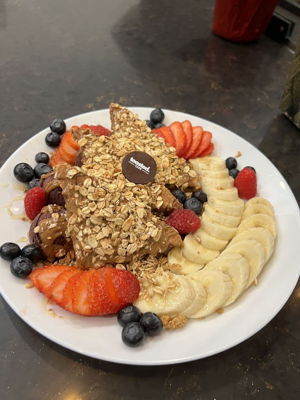 Açaí Plate at Toasted Cafe in Montrose — Açaí sorbet, seasonal fruit medley, granola, almond butter, honey.