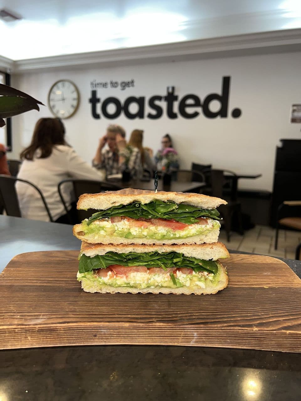 Avocado toast with feta, sprouts, and balsamic — a vegan-tagged option at Toasted Cafe