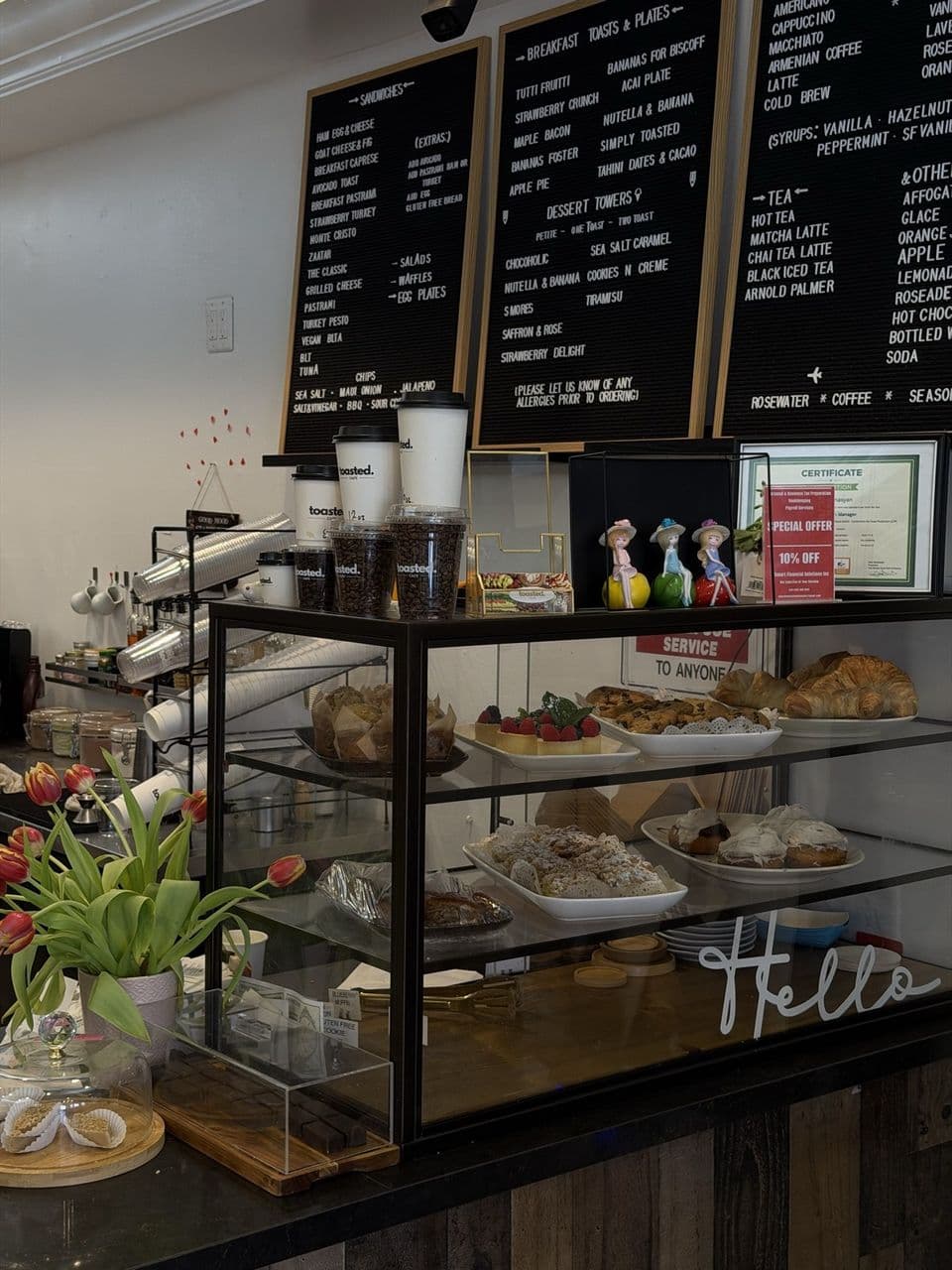 The interior of Toasted Cafe in Montrose — counter, pastries, and tables that work for a laptop day
