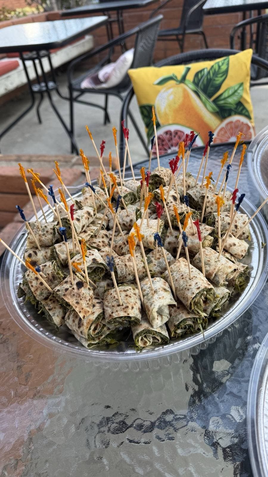 Tray of lavash rolls filled with herbs and greens, ready for pickup on the Toasted patio