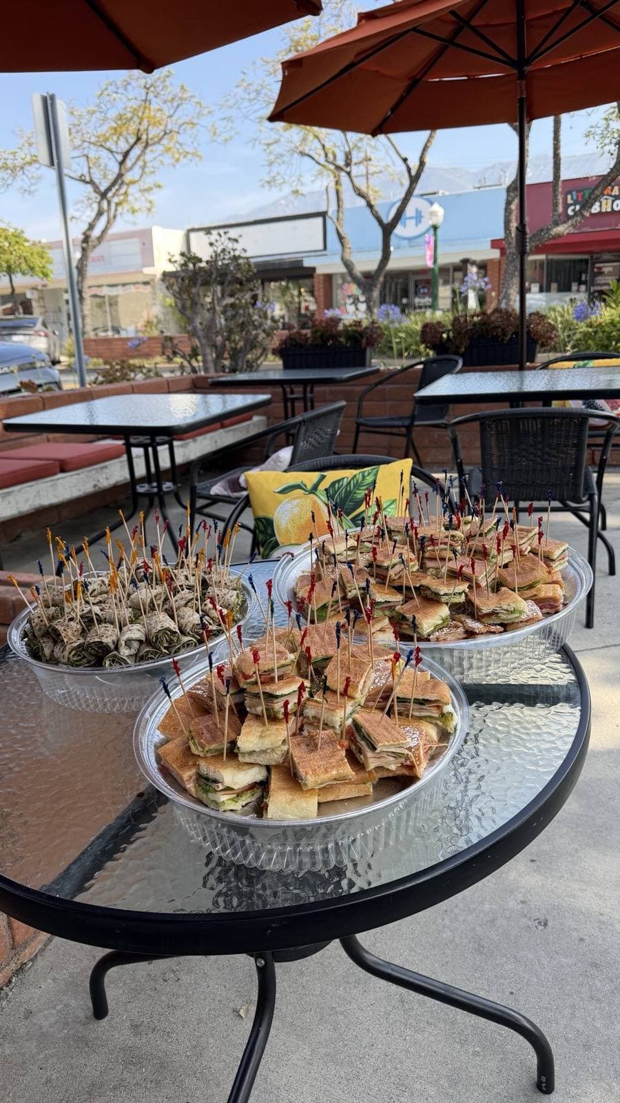Craft services — catering trays staged on the Toasted patio, ready for pickup