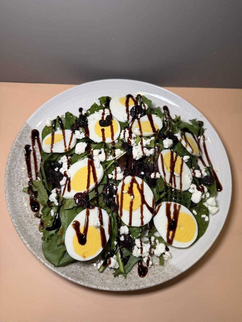 Goat Cheese Salad at Toasted Cafe in Montrose — Goat cheese, egg and cranberries over fresh spring mix, finished with the sweet dressing.