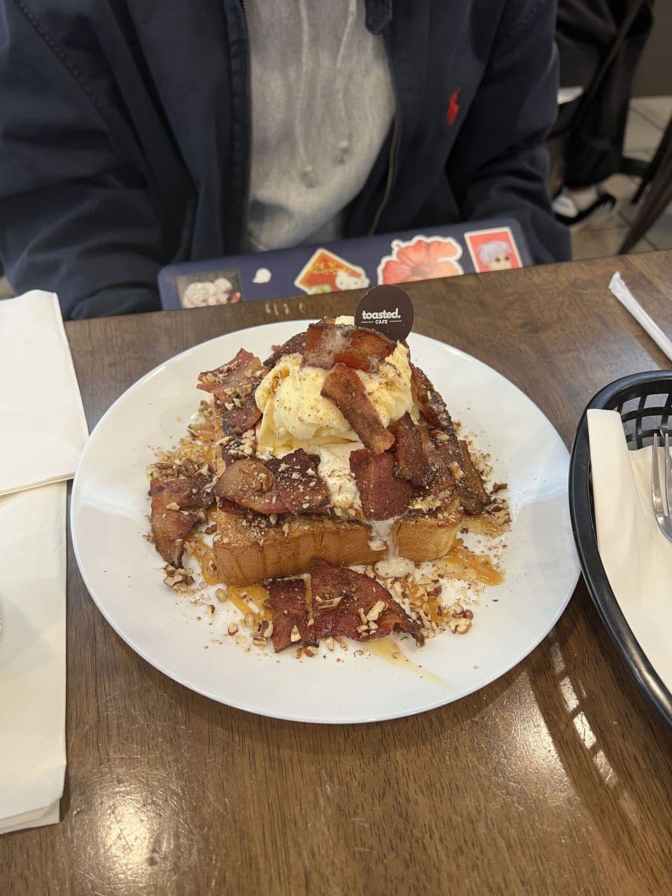 Maple Bacon at Toasted Cafe in Montrose — Crispy bacon, caramel sauce, maple syrup, honey, whip cream, pecans.