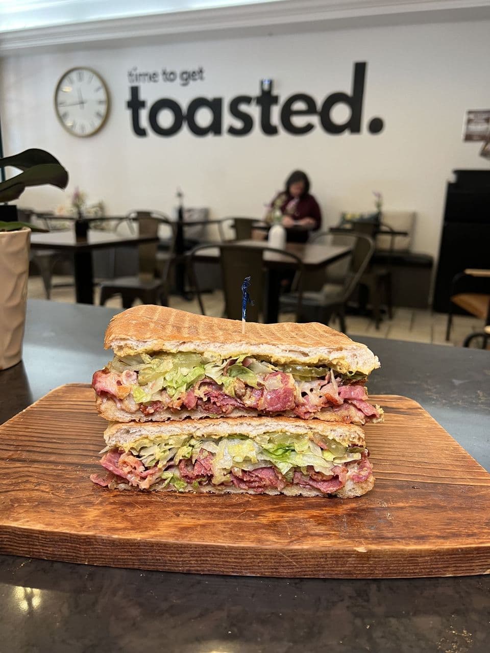 Monte Cristo at Toasted Cafe in Montrose — Ham, turkey, mayo, red pepper jelly, Monterey jack, tomato — topped with powdered sugar.