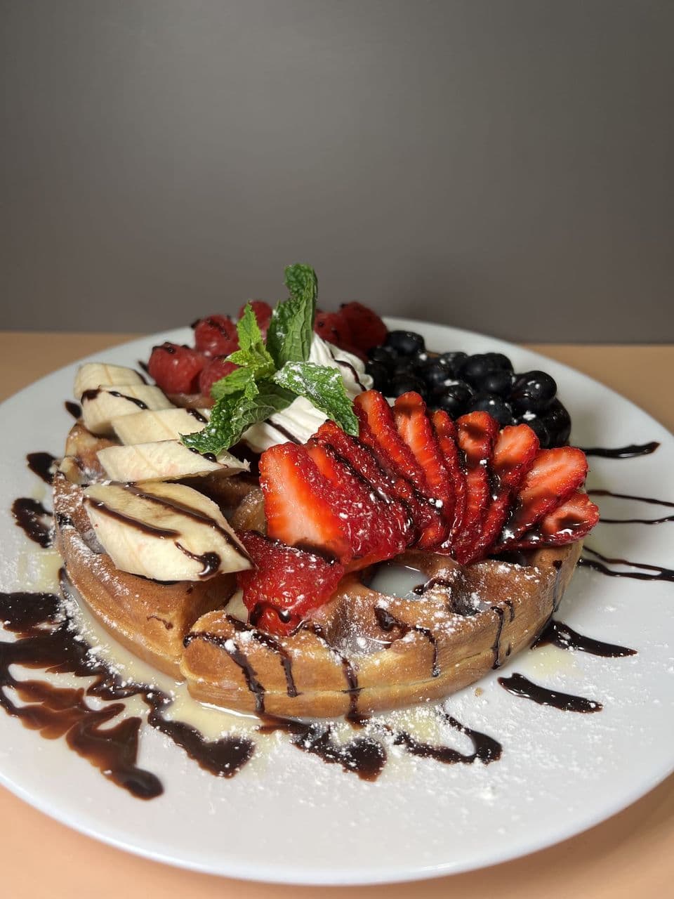 Catering spread of breakfast sandwiches, toasts, fruit, and coffee from Toasted Cafe