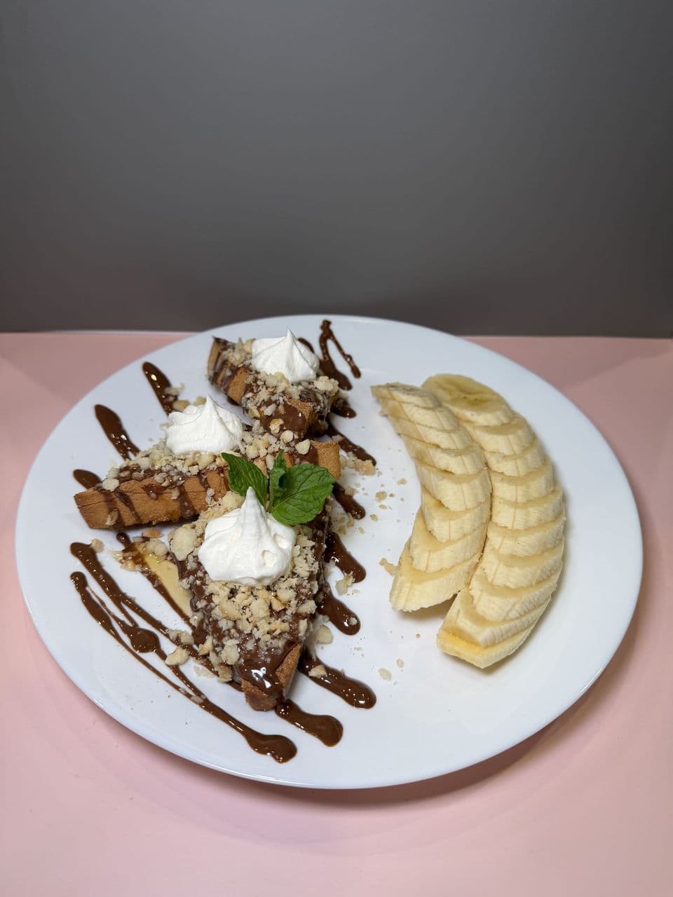 Nutella & Banana Plate at Toasted Cafe in Montrose — Nutella and banana on thick-cut toast with hazelnuts, honey and whip cream — the single-plate cousin of our Tower.