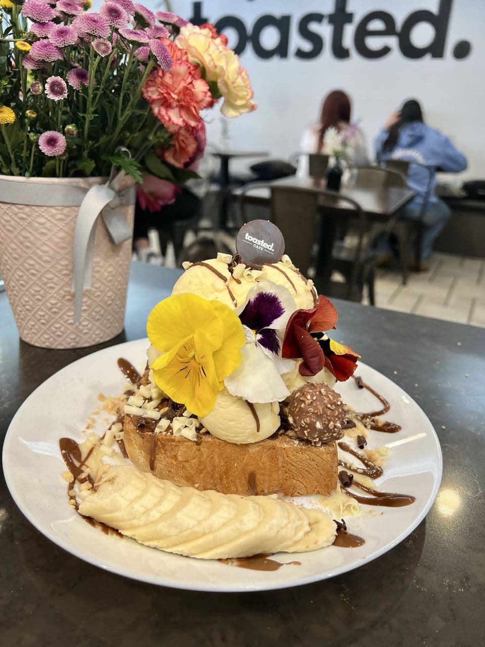 Nutella & Banana at Toasted Cafe in Montrose — Vanilla ice cream, Nutella & honey glaze, Ferrero Rocher / milk chocolates, banana, hazelnuts, whip cream.