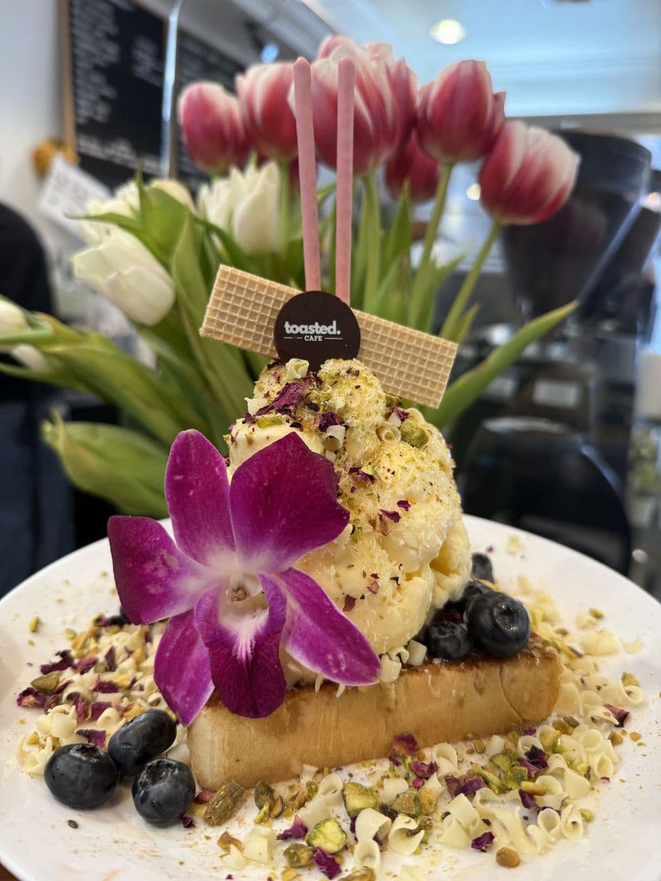 Saffron & Rose Toast Tower with rose petals, pistachios, and blueberries