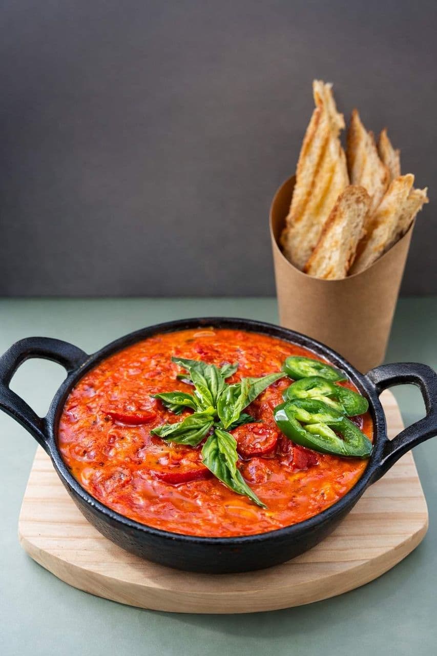 Shakshuka at Toasted Cafe in Montrose — Tomatoes, eggs, basil, jalapeño, toasted bread.