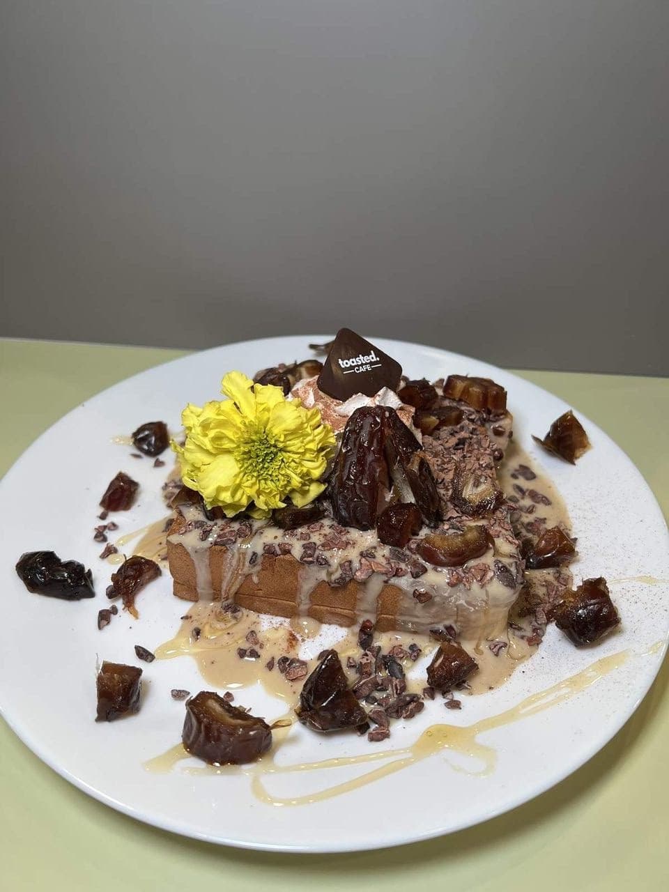 Tahini, Dates & Dark Cacao at Toasted Cafe in Montrose — Tahini and dates on thick-cut toast, cacao nibs and cocoa over the top, honey and whip cream to finish.