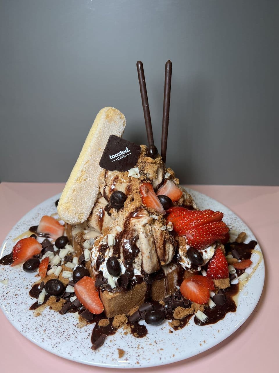 Tiramisu Tower at Toasted Cafe in Montrose — Coffee ice cream, caramel & chocolate glaze, lady finger, espresso beans, mascarpone, honey, whip cream, strawberries.