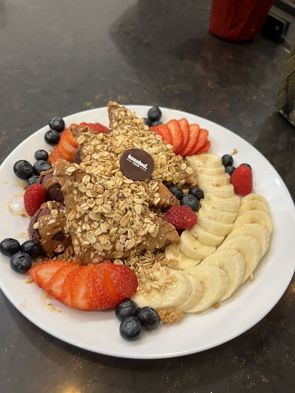 Açaí Plate at Toasted Cafe in Montrose — Açaí sorbet, seasonal fruit medley, granola, almond butter, honey.