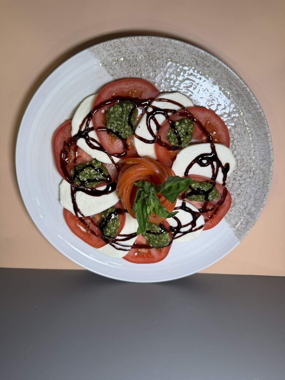 Caprese Salad at Toasted Cafe in Montrose — Tomatoes, mozzarella, basil, pesto, balsamic glaze.