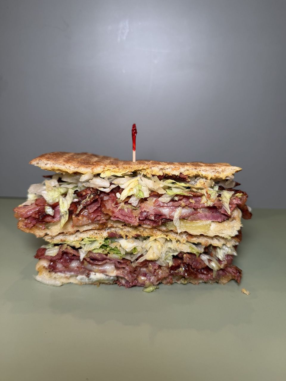 Pastrami at Toasted Cafe in Montrose — Pastrami, provolone, spicy mustard, mayo, pickles, lettuce, sauerkraut.