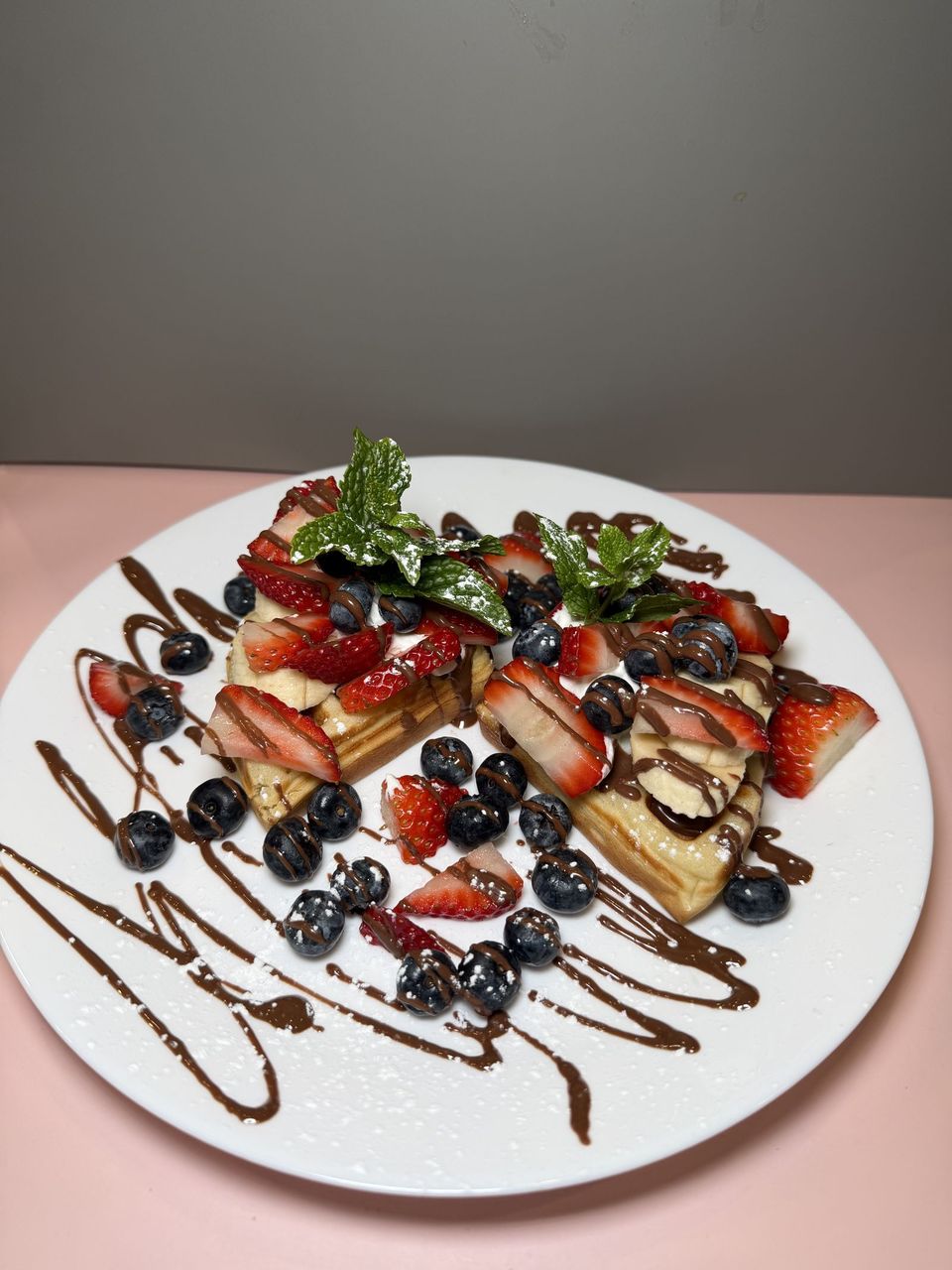 Waffle Wonderland at Toasted Cafe in Montrose — Small waffle, strawberry, blueberry, honey, whipped cream, Nutella, banana.